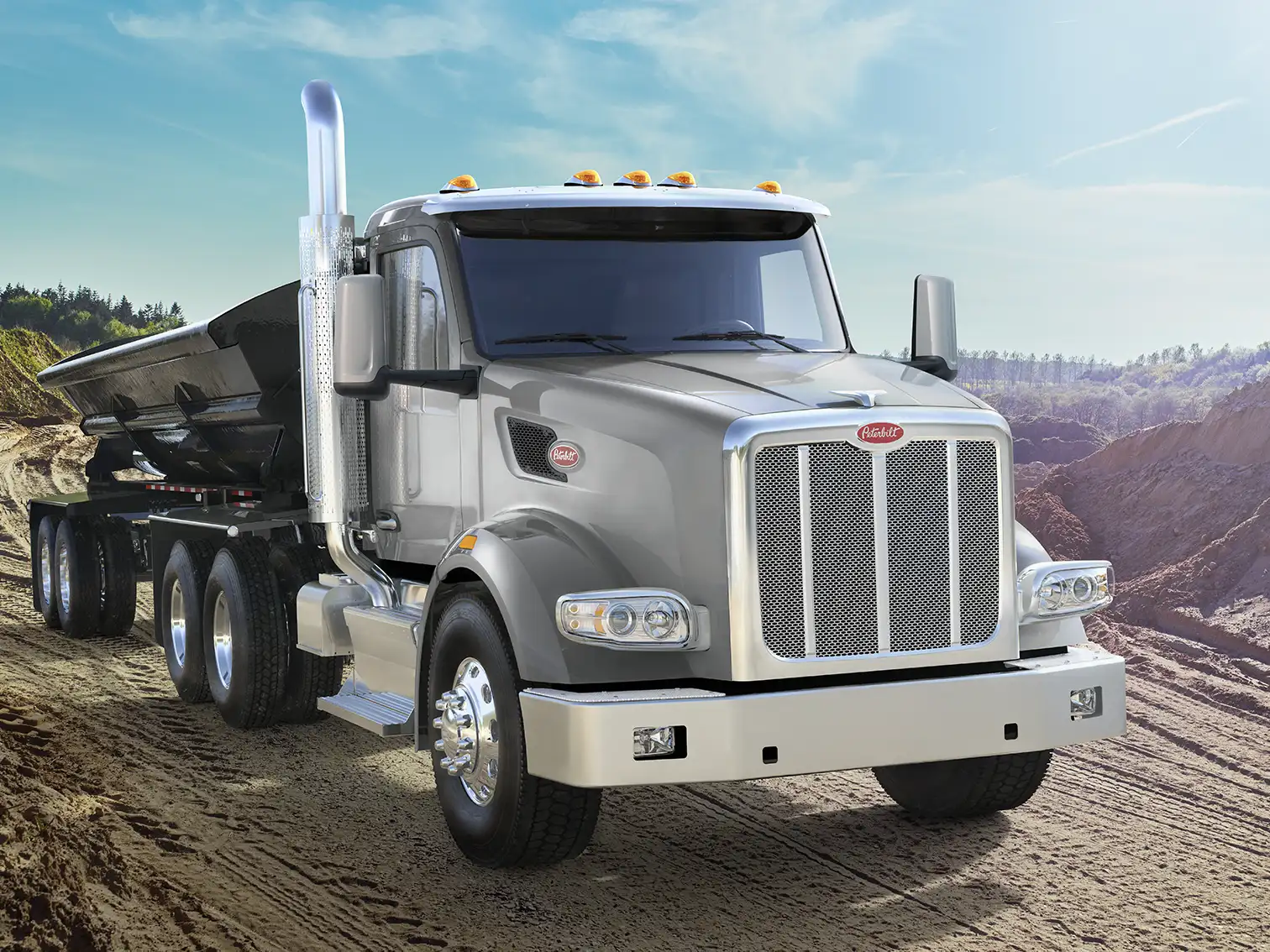 Silver and chrome Peterbilt hauler working on a construction site